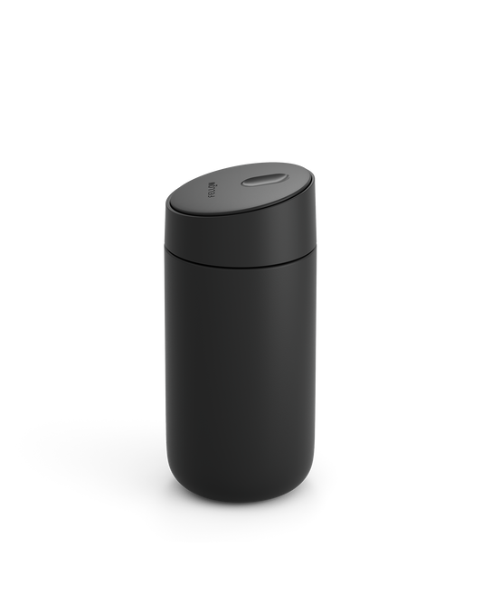 Fellow Carter Slide Mug—matte black, cylindrical, rounded lid, shown on white background.
